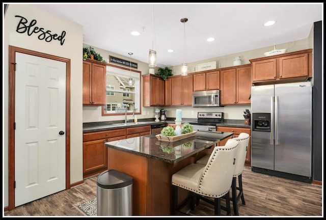 8065 Kirkwood Ln N Unit 82, Maple Grove, MN 55369 - kitchen with stainless steel appliances, dark wood-style flooring, brown cabinets, a center island, and a kitchen bar