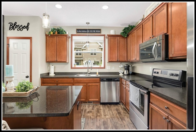 8065 Kirkwood Ln N Unit 82, Maple Grove, MN 55369 - kitchen featuring stainless steel appliances, wood finished floors, brown cabinetry, decorative light fixtures, and recessed lighting