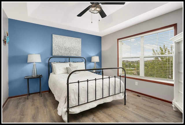 8065 Kirkwood Ln N Unit 82, Maple Grove, MN 55369 - bedroom featuring a raised ceiling, wood finished floors, and ceiling fan