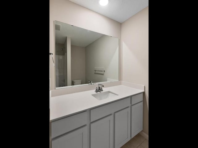 6720 376th St, North Branch, MN 55056 - bathroom with vanity, toilet, tile patterned flooring, and baseboards