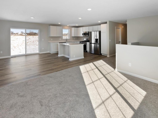 6720 376th St, North Branch, MN 55056 - kitchen with stainless steel appliances, white cabinets, open floor plan, baseboards, and recessed lighting