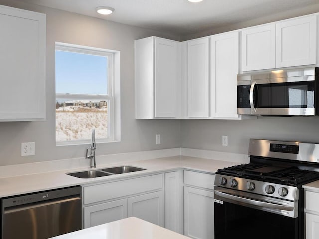 6720 376th St, North Branch, MN 55056 - kitchen featuring stainless steel appliances, a sink, and white cabinets