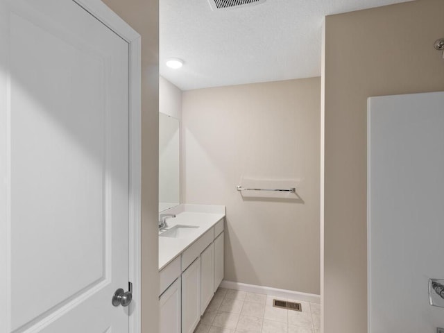 6720 376th St, North Branch, MN 55056 - bathroom featuring vanity, baseboards, tile patterned flooring, and a textured ceiling