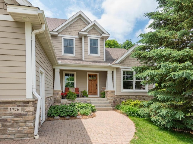 1776 Lockridge Ct, Waconia, MN 55387 - entrance to property with covered porch, roof with shingles, and stone siding