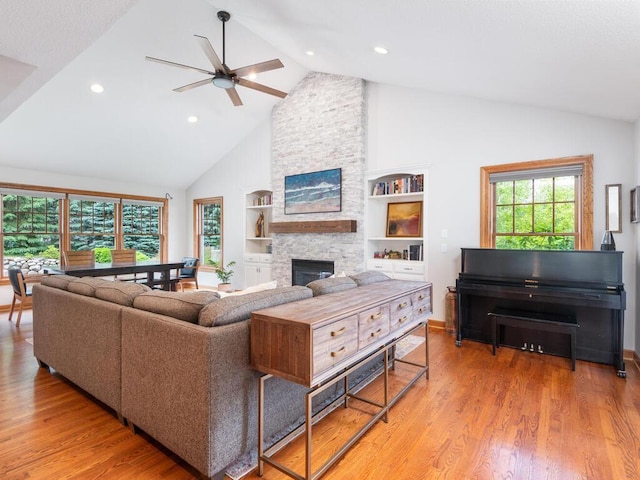 1776 Lockridge Ct, Waconia, MN 55387 - living area with ceiling fan, high vaulted ceiling, a stone fireplace, wood finished floors, and built in features