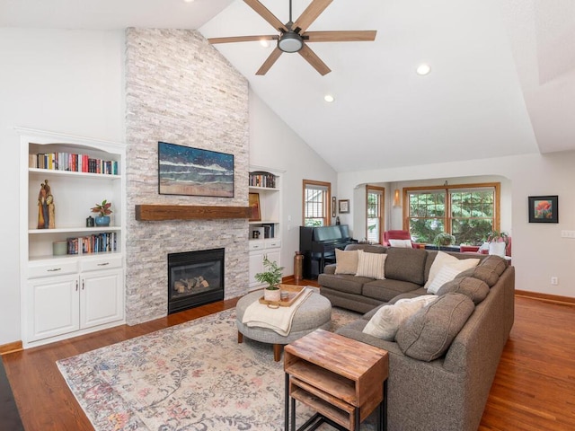 1776 Lockridge Ct, Waconia, MN 55387 - living room with high vaulted ceiling, a ceiling fan, a stone fireplace, wood finished floors, and baseboards