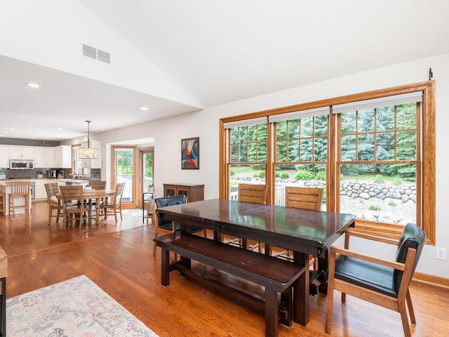1776 Lockridge Ct, Waconia, MN 55387 - dining space featuring light wood-style flooring, vaulted ceiling, and recessed lighting