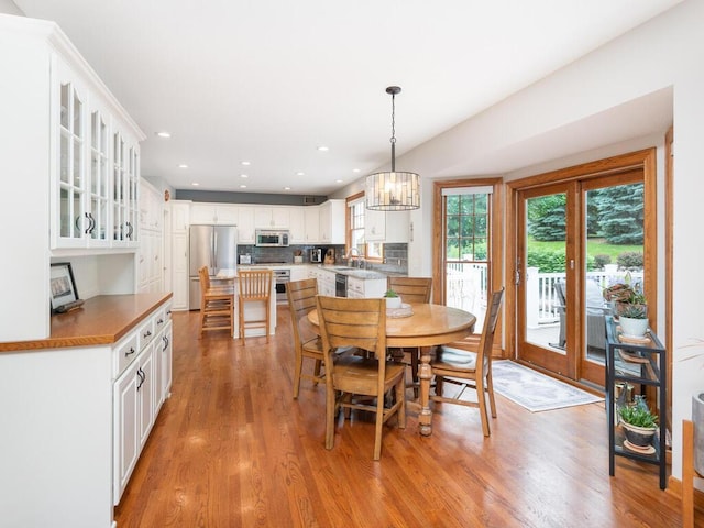 1776 Lockridge Ct, Waconia, MN 55387 - dining room featuring light wood-style floors, a chandelier, and recessed lighting