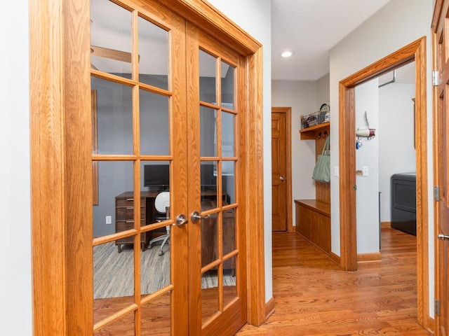 1776 Lockridge Ct, Waconia, MN 55387 - hall featuring french doors, wood finished floors, washer / clothes dryer, baseboards, and a desk