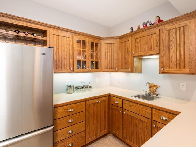 1776 Lockridge Ct, Waconia, MN 55387 - kitchen with freestanding refrigerator, a sink, light countertops, and brown cabinets