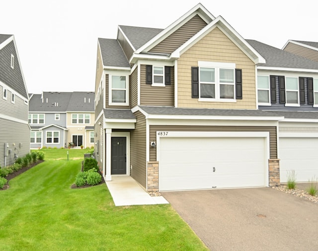 4837 Avery Ct, Eagan, MN 55123 - view of front of house with stone siding, driveway, a front lawn, and a garage