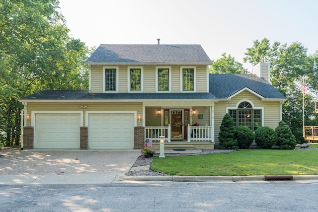 957 Belvista Dr, North Mankato, MN 56003 - view of front of home with a porch, a chimney, driveway, and brick siding