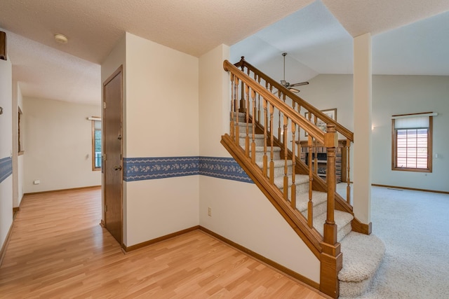 957 Belvista Dr, North Mankato, MN 56003 - stairway with a ceiling fan, wood finished floors, baseboards, lofted ceiling, and a textured ceiling