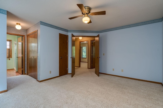 957 Belvista Dr, North Mankato, MN 56003 - spare room featuring light carpet, a ceiling fan, and baseboards