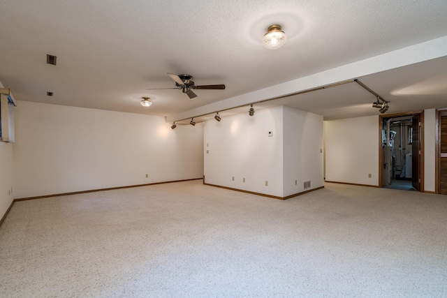 957 Belvista Dr, North Mankato, MN 56003 - unfurnished room featuring ceiling fan, baseboards, and rail lighting