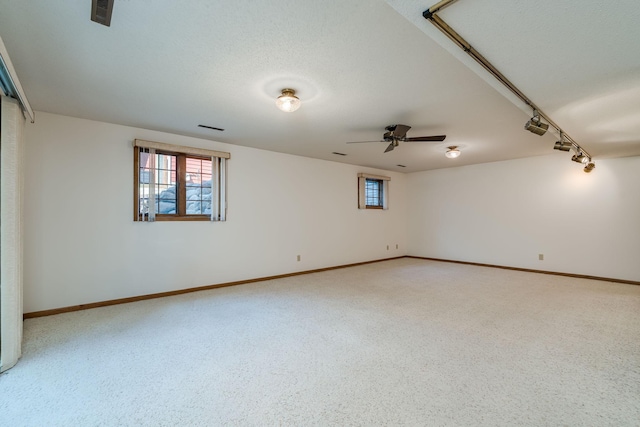 957 Belvista Dr, North Mankato, MN 56003 - empty room featuring healthy amount of natural light, baseboards, a ceiling fan, and light carpet
