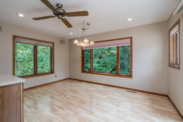 957 Belvista Dr, North Mankato, MN 56003 - unfurnished room with light wood-style flooring, a ceiling fan, baseboards, recessed lighting, and a textured ceiling