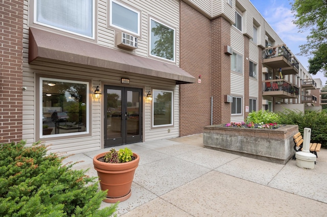 2800 Hillsboro Ave N Unit 214, New Hope, MN 55427 - entrance to property with french doors, cooling unit, a patio area, and brick siding