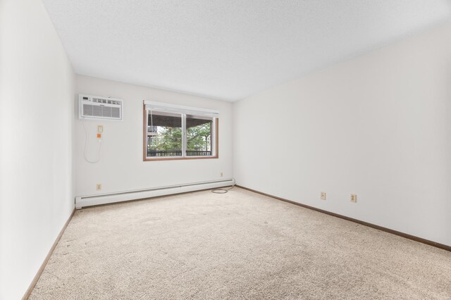 2800 Hillsboro Ave N Unit 214, New Hope, MN 55427 - spare room featuring baseboard heating, carpet flooring, and an AC wall unit