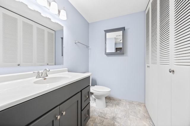 2800 Hillsboro Ave N Unit 214, New Hope, MN 55427 - bathroom featuring a closet, vanity, and stone finish floors