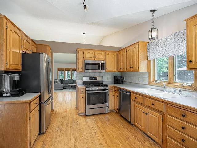 5956 Norway Pine Ct, White Bear Twp, MN 55110 - kitchen featuring appliances with stainless steel finishes, a sink, decorative backsplash, light wood finished floors, and light countertops