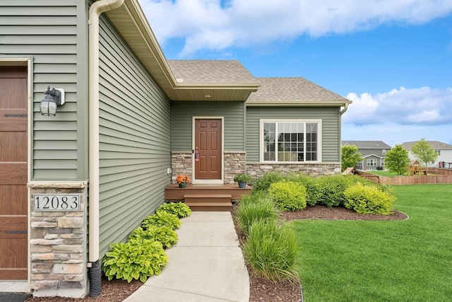 12083 79th St NE, Otsego, MN 55330 - entrance to property featuring a lawn, a shingled roof, and stone siding