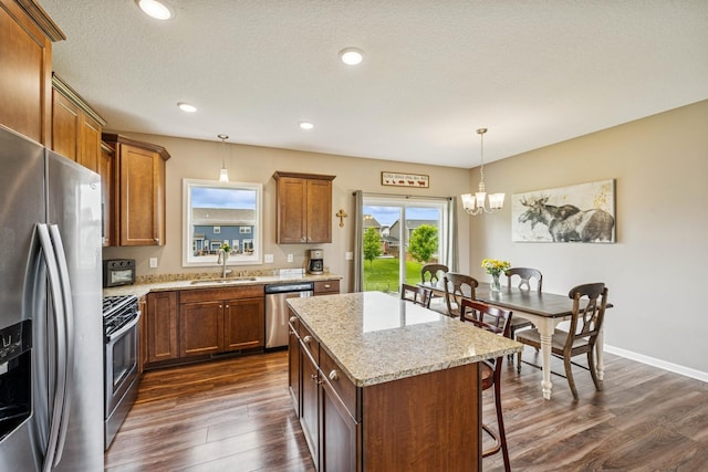 12083 79th St NE, Otsego, MN 55330 - kitchen with appliances with stainless steel finishes, a chandelier, dark wood-style floors, a sink, and recessed lighting