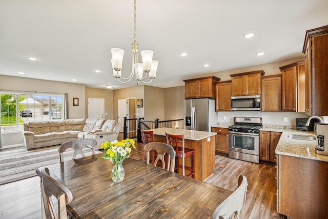 12083 79th St NE, Otsego, MN 55330 - dining area with recessed lighting, wood finished floors, and a chandelier