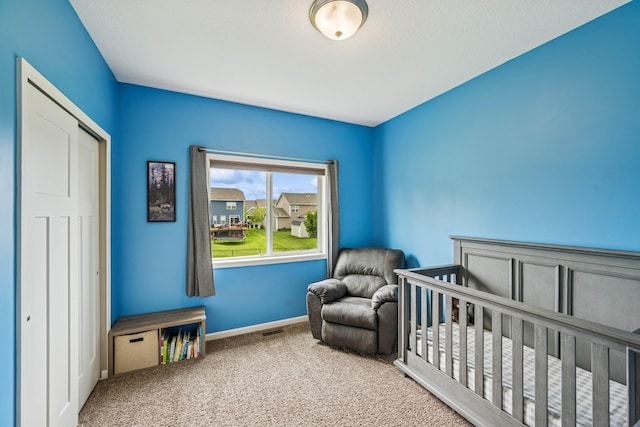 12083 79th St NE, Otsego, MN 55330 - bedroom featuring carpet floors, baseboards, and a crib