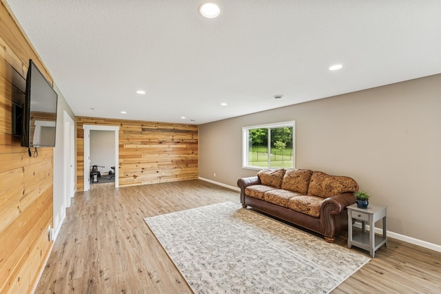 12083 79th St NE, Otsego, MN 55330 - living room with wooden walls, light wood-type flooring, recessed lighting, and baseboards