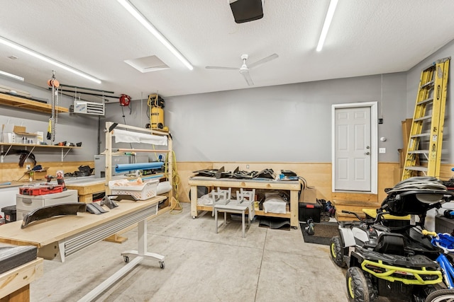 12083 79th St NE, Otsego, MN 55330 - misc room featuring a workshop area, concrete floors, a textured ceiling, and wainscoting