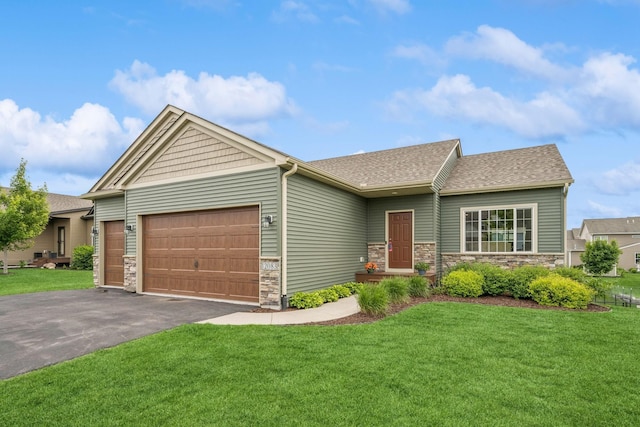 12083 79th St NE, Otsego, MN 55330 - view of front facade with stone siding, an attached garage, driveway, a front lawn, and roof with shingles