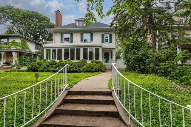 2516 Humboldt Ave S, Minneapolis, MN 55405 - view of front of property with a balcony, a chimney, and stucco siding