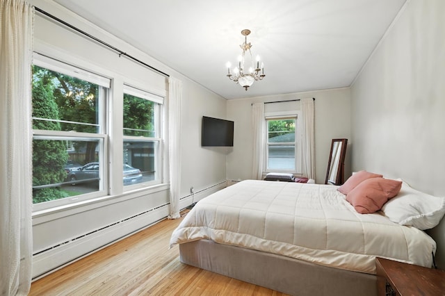 2516 Humboldt Ave S, Minneapolis, MN 55405 - bedroom with a chandelier, wood finished floors, and a baseboard radiator