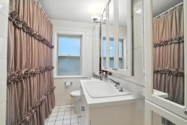 2516 Humboldt Ave S, Minneapolis, MN 55405 - bathroom with tile patterned flooring, tile walls, and vanity