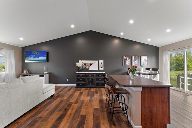 809 Cologne Ln, Waverly, MN 55390 - kitchen featuring lofted ceiling, a kitchen island, recessed lighting, dark countertops, and open floor plan