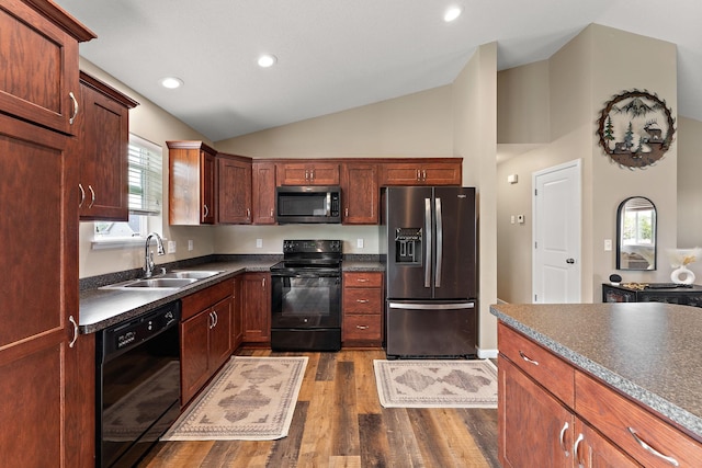 809 Cologne Ln, Waverly, MN 55390 - kitchen with black appliances, dark countertops, vaulted ceiling, dark wood-style floors, and recessed lighting