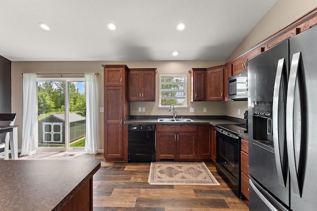 809 Cologne Ln, Waverly, MN 55390 - kitchen with black appliances, dark countertops, dark wood-type flooring, recessed lighting, and vaulted ceiling