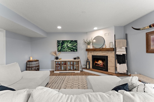 809 Cologne Ln, Waverly, MN 55390 - living area with wood finished floors, a stone fireplace, recessed lighting, and a textured ceiling