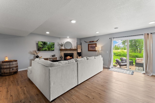 809 Cologne Ln, Waverly, MN 55390 - living area featuring wood finished floors, a brick fireplace, recessed lighting, and a textured ceiling