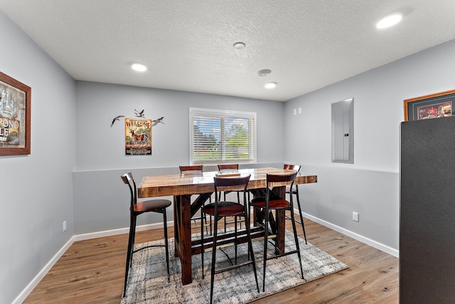 809 Cologne Ln, Waverly, MN 55390 - dining space with electric panel, light wood-type flooring, a textured ceiling, and recessed lighting