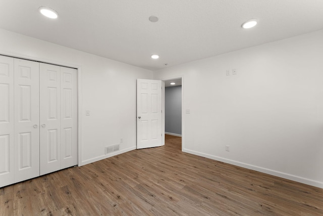 809 Cologne Ln, Waverly, MN 55390 - unfurnished bedroom with wood finished floors, recessed lighting, and a closet