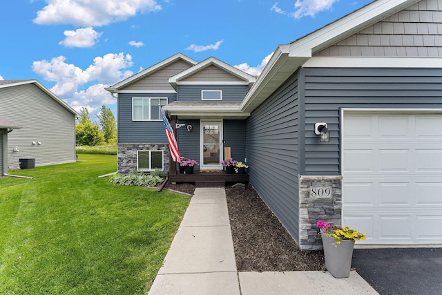 809 Cologne Ln, Waverly, MN 55390 - tri-level home featuring stone siding, a front lawn, and a garage
