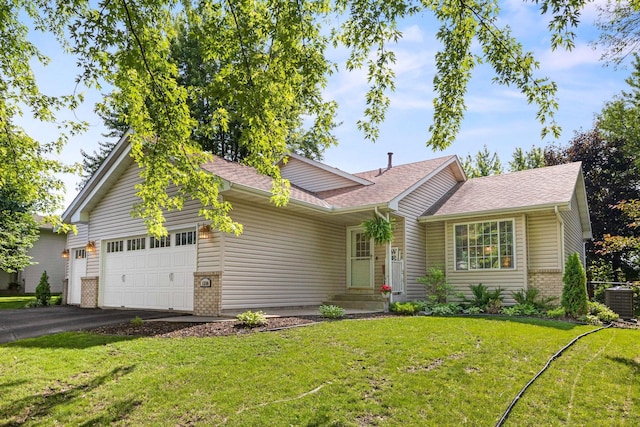 1590 Fountain Ln, Waconia, MN 55387 - single story home featuring brick siding, a garage, asphalt driveway, and a front yard