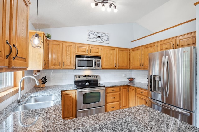 1590 Fountain Ln, Waconia, MN 55387 - kitchen featuring appliances with stainless steel finishes, lofted ceiling, backsplash, stone countertops, and pendant lighting