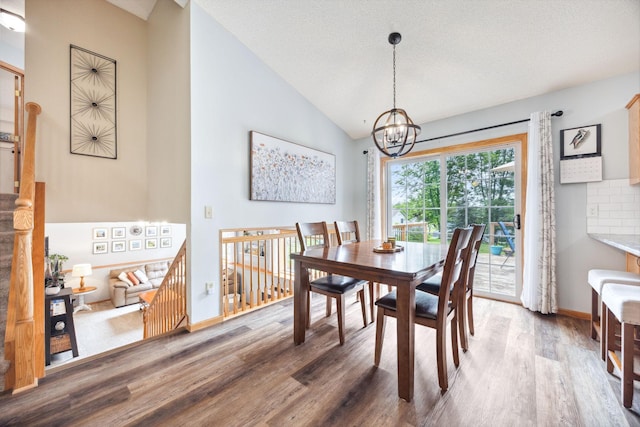 1590 Fountain Ln, Waconia, MN 55387 - dining area with wood finished floors, a chandelier, and high vaulted ceiling