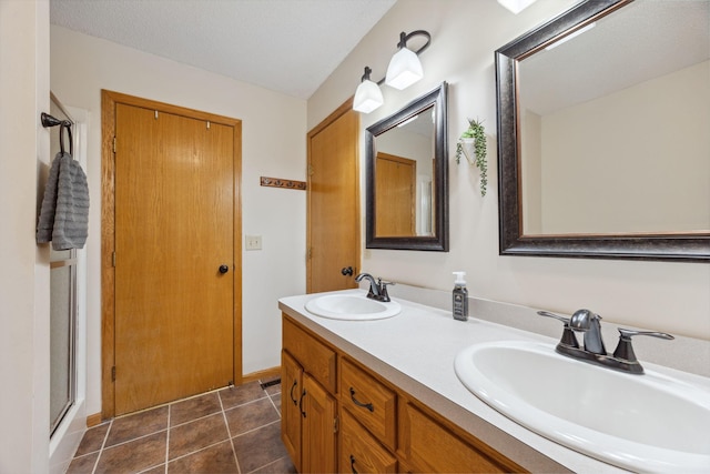 1590 Fountain Ln, Waconia, MN 55387 - bathroom with double vanity, tile patterned flooring, and a shower with door