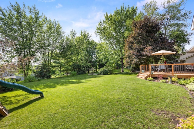 1590 Fountain Ln, Waconia, MN 55387 - view of green lawn with a playground and a wooden deck