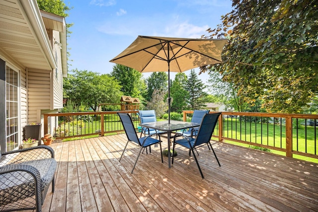 1590 Fountain Ln, Waconia, MN 55387 - deck featuring outdoor dining area, a yard, and a playground