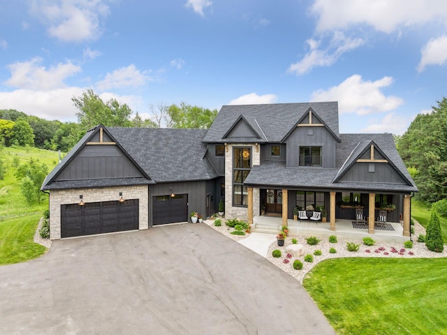 11278 Eastwood Ave SE, Delano, MN 55328 - modern inspired farmhouse featuring driveway, an attached garage, a porch, a shingled roof, and a front yard
